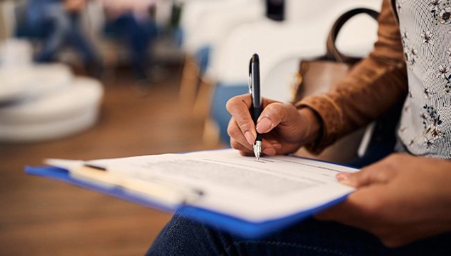 Patient filling out forms in lobby