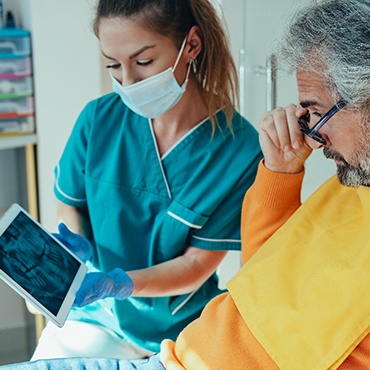 Patient at dentist looking at X-rays