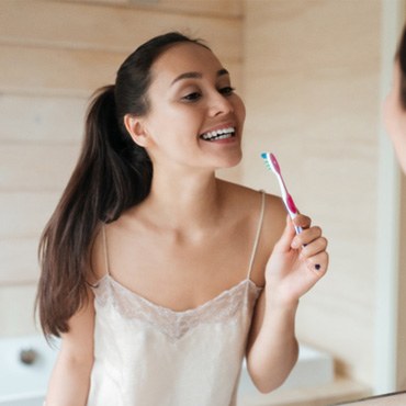 Woman holding a toothbrush