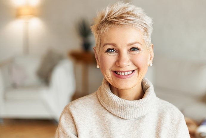 woman wearing turtleneck smiling