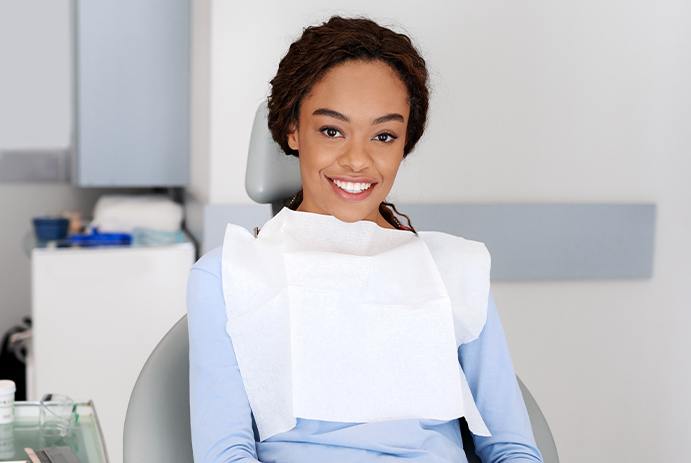 youn woman smiling at camera in chair