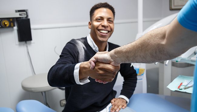 man shaking dentist hand