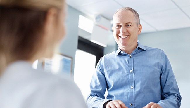 man in blue shirt smiling