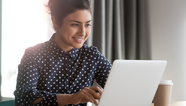 woman wearing polka dot shirt working