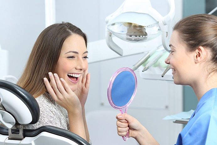 woman checking smile in circle mirror