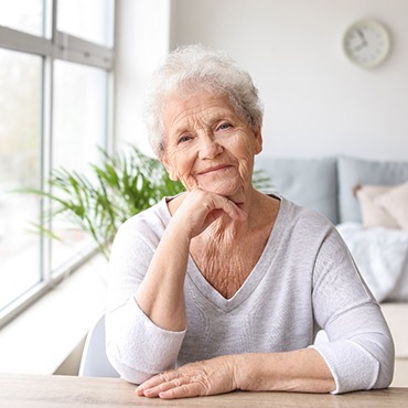 Smiling senior woman, possibly at risk for gum disease