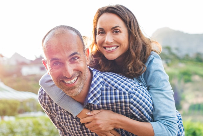 husband giving wife piggyback ride