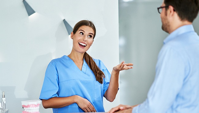 team member happily talking to patient