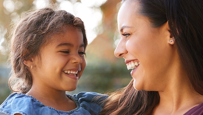 mother and daughter smiling at each other