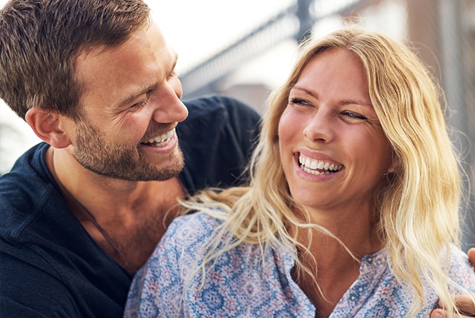 man and woman laughing and smiling