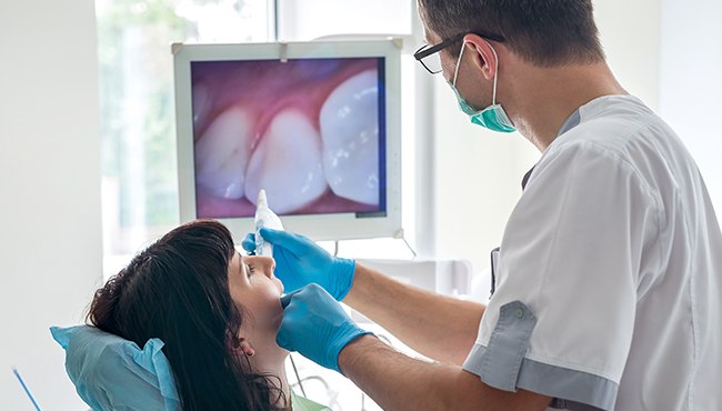 dentist using intraoral camera