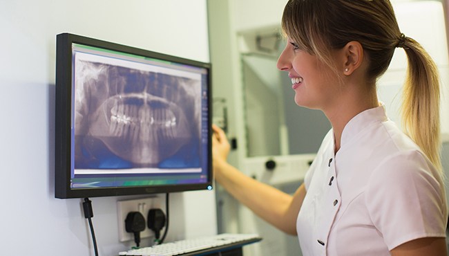 team member looking at x-ray