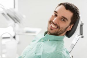 Smiling man in the dental chair. 