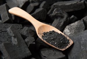 activated charcoal powder in a scoop