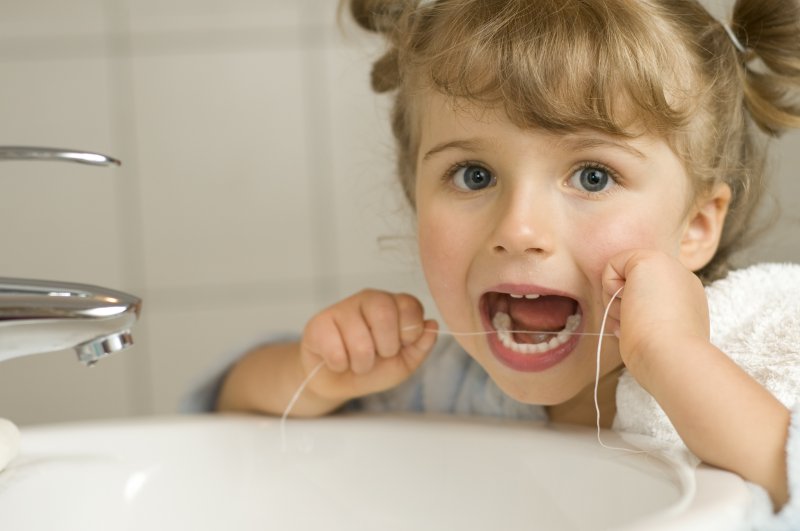 Young girl flossing