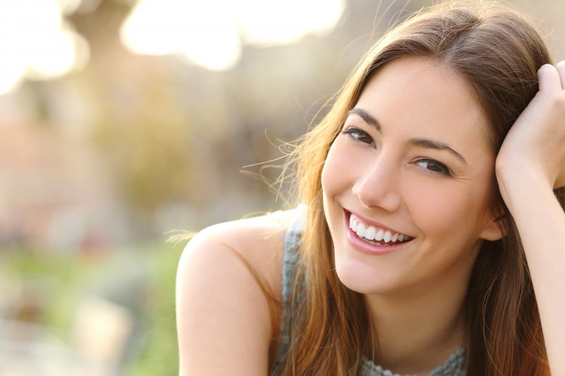 young woman smiling outside