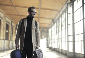 Smiling man holding luggage 