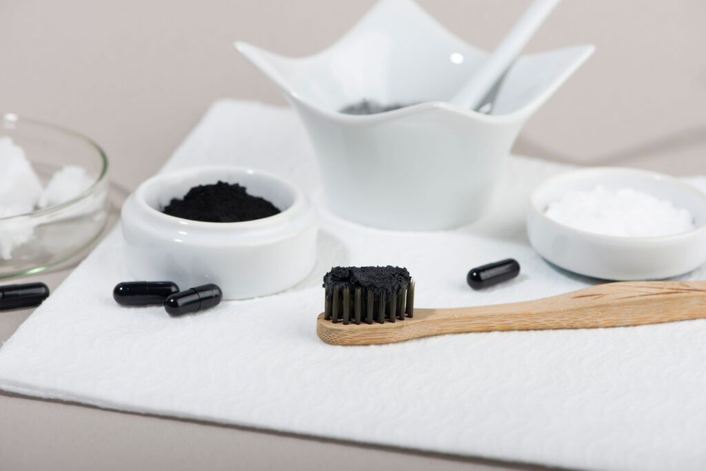 Activated charcoal next to toothbrush